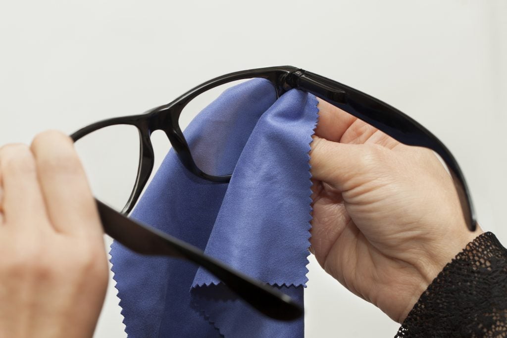 Woman cleaning glasses at home