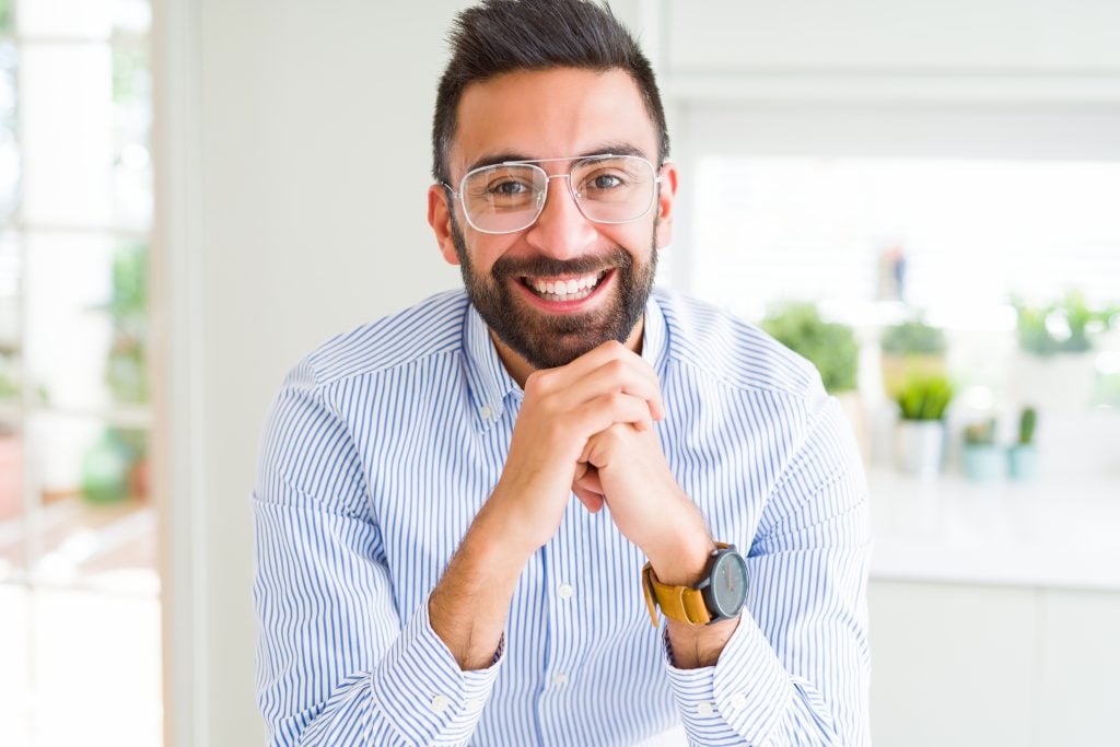 Man wearing thin-frame aviator glasses