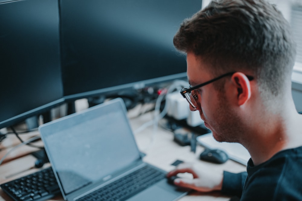 Man Looking at computer screen with glasses.