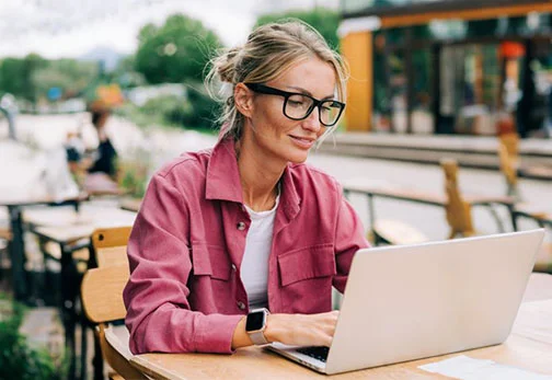 women in glasses using laptop