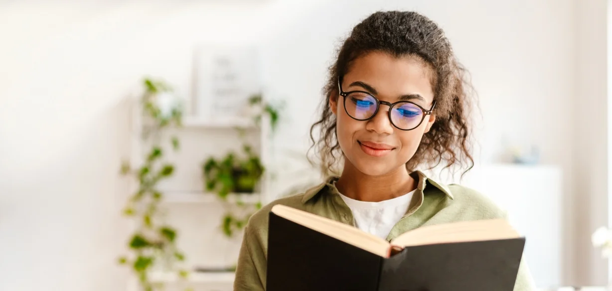 woman in glasses reading a book