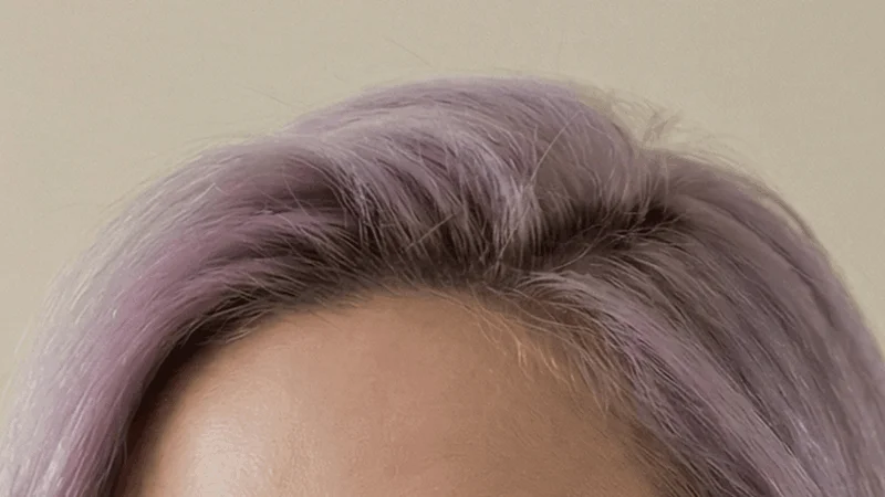 Person with dyed fashion-colour hair wearing glasses