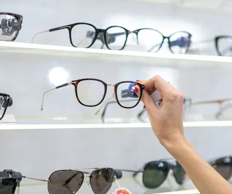 Customer browsing and selecting prescription glasses frames in our showroom