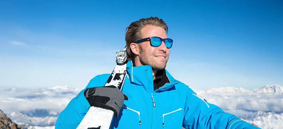 Skier wearing prescription ski goggles on a snowy mountain