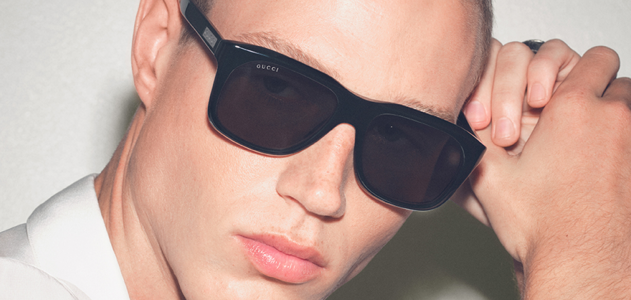 man wearing a bold black pair of gucci sunglasses
