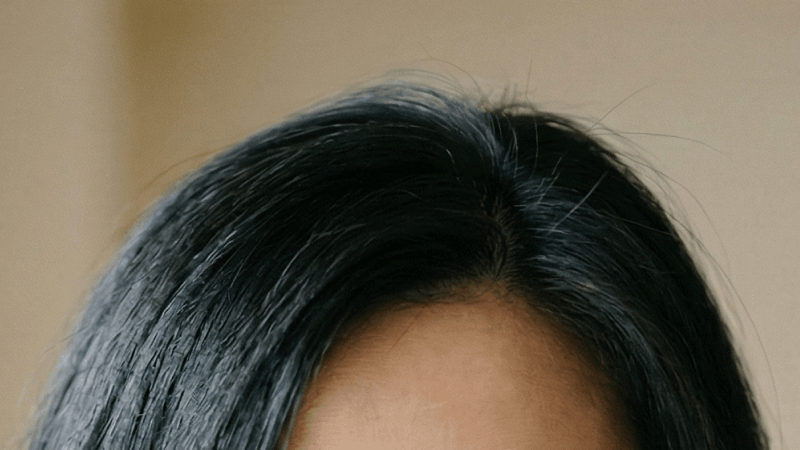 Person with black hair wearing glasses