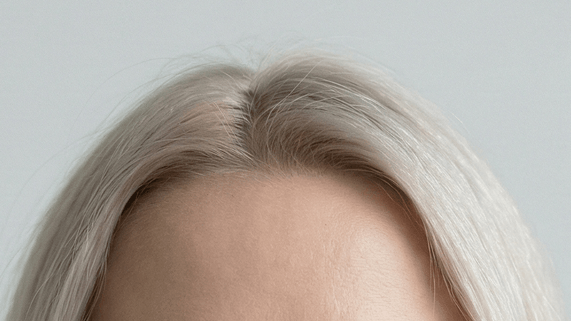 Person with blonde hair wearing glasses