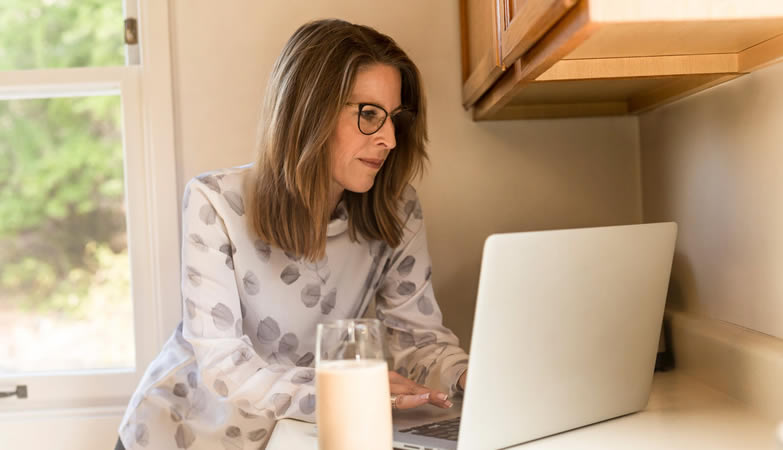 Woman in a kitchen buying glasses online