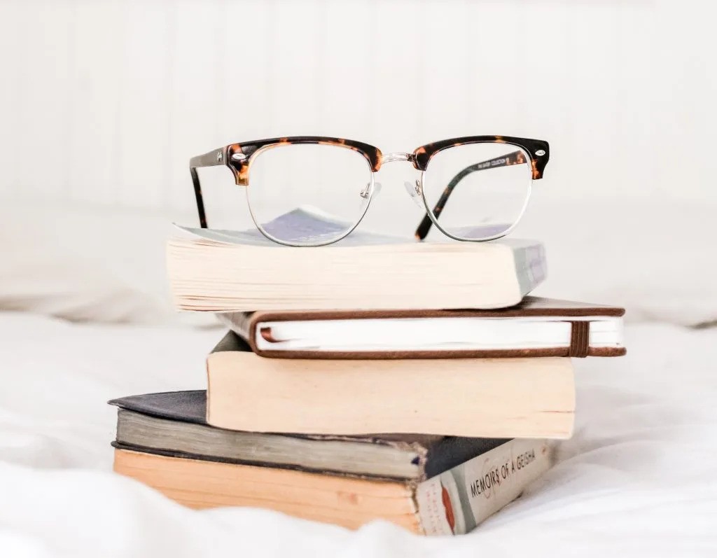 Glasses on a pile of books