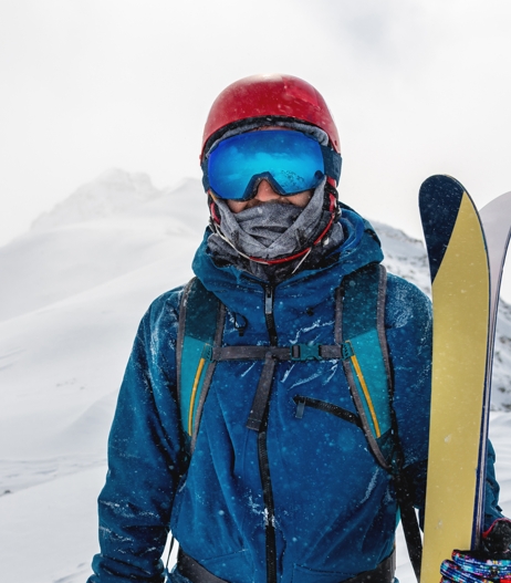 man with ski goggles and skis
