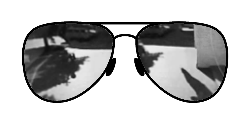 Mirrored sunglass lens with a silver tint, reflecting light